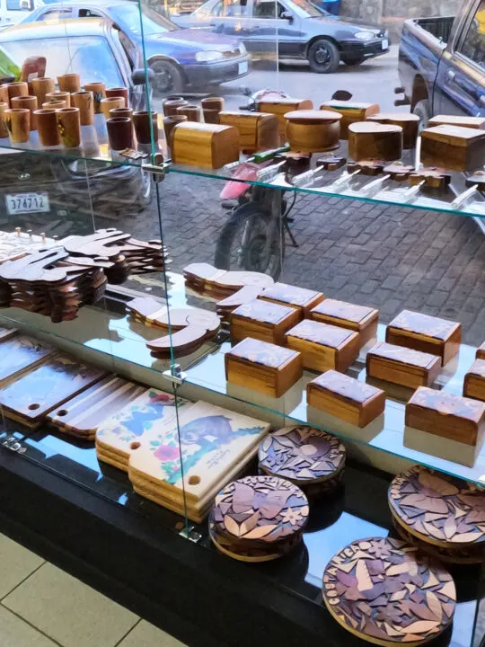 wood carved trinkets sitting on shelves