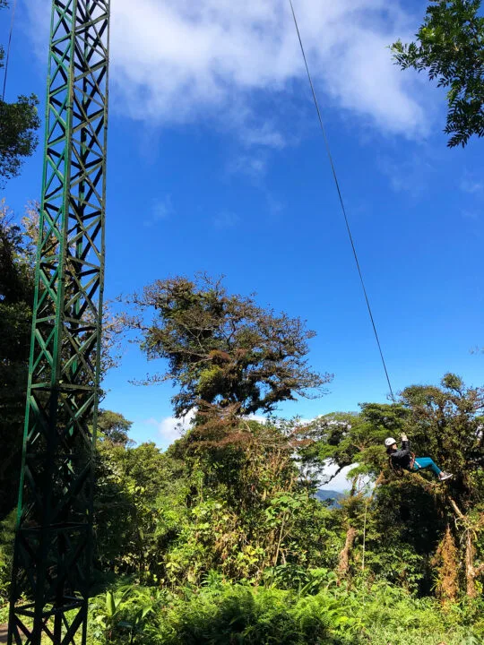 tarzan swing Monteverde biplane experience view of woman on swing in jungle