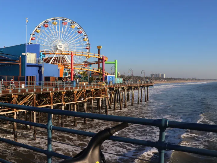 Los Angeles boardwalk with carnival rides and ocean on a warm winter getaway in usa