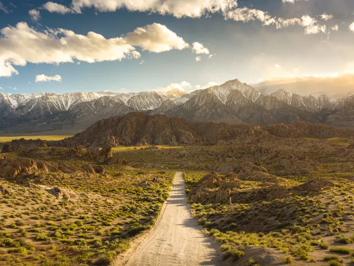 alabama hills with snow capped mountains and road