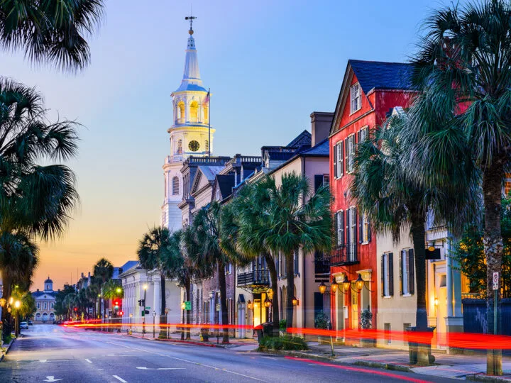 Main Street Charleston South Carolina at dusk with buildings palm trees and street