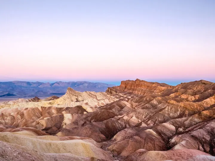 things to do near Las Vegas Death Valley deep brown rocky ridges at sunset