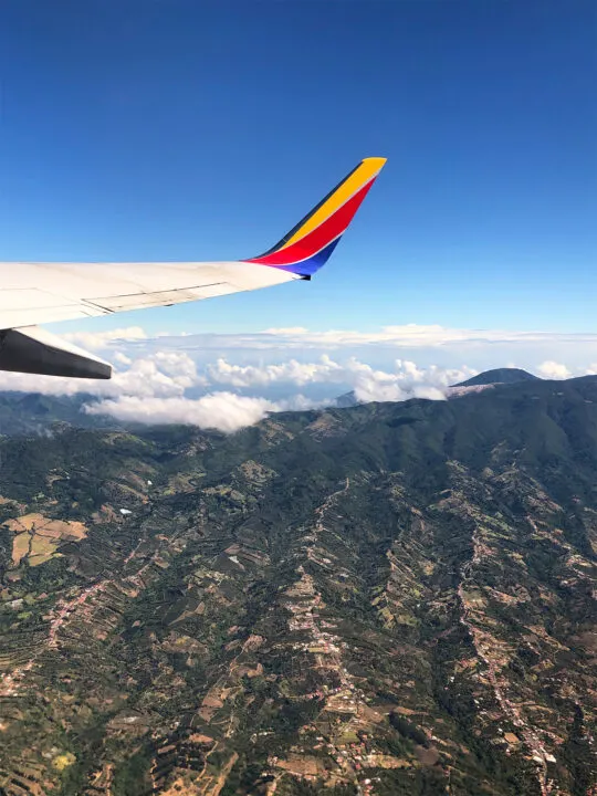 Manuel Antonio airport view of airplane wing with Costa Rica mountains below