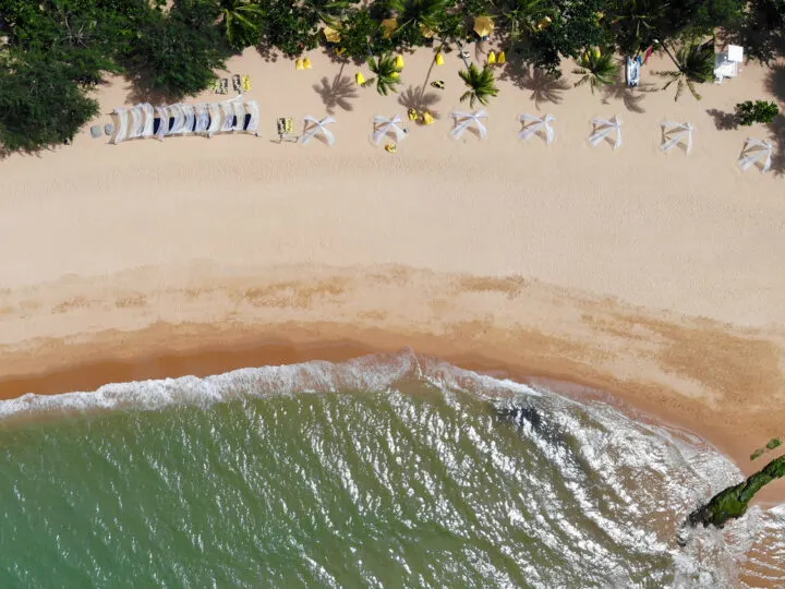 khao lak thailand beach looking down sand green water and trees