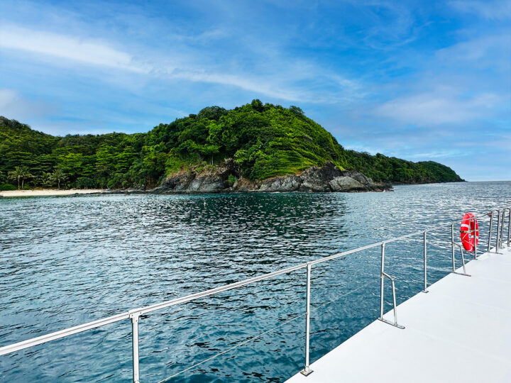 view of boat edge and land with ocean water on Manuel Antonio catamaran tour