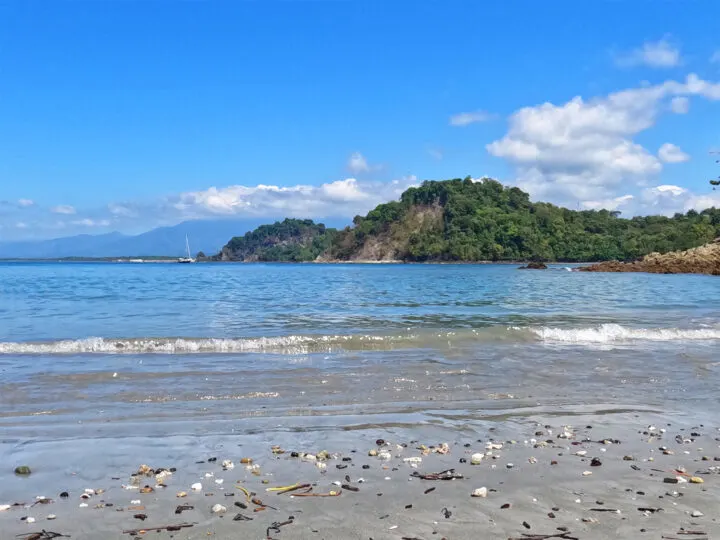 beach view of rocky shore with land across bay