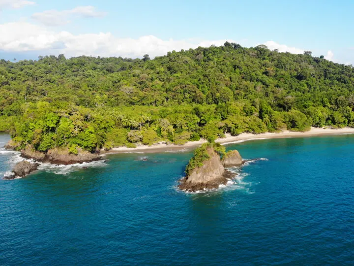 Manuel Antonio national park view from ocean above with rocky coastline and trees
