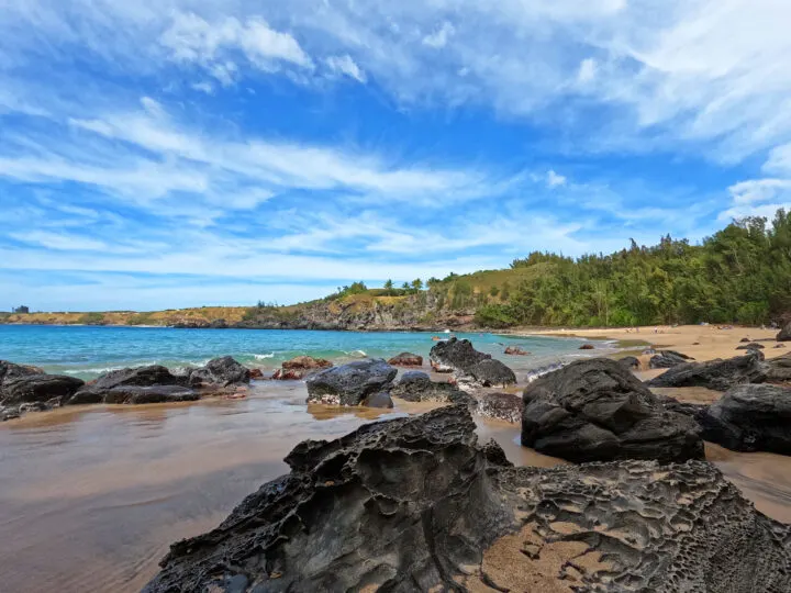 view of rocky beach and coastline blue water and sky