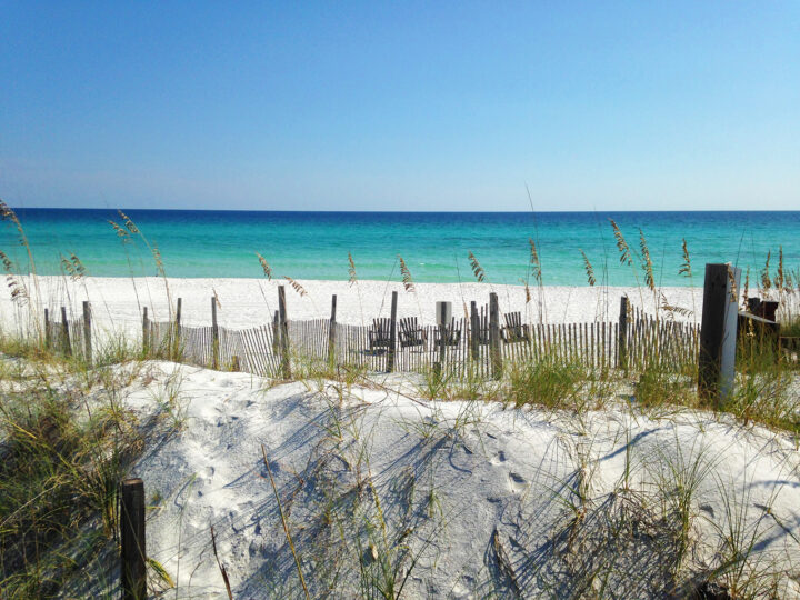 view of beach and sand dunes with fence in destin florida warm winter vacations in the US