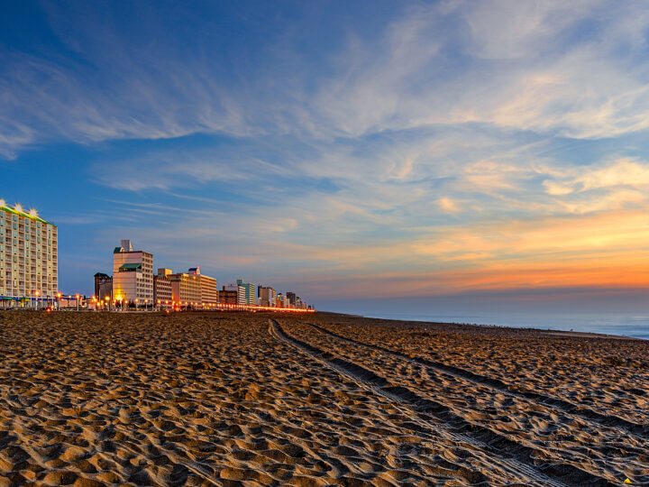 beach at dusk with city in distance best family vacations spring break