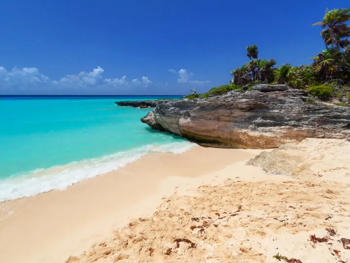 beaches in Mexico with tan sand turquoise water and rocky shoreline
