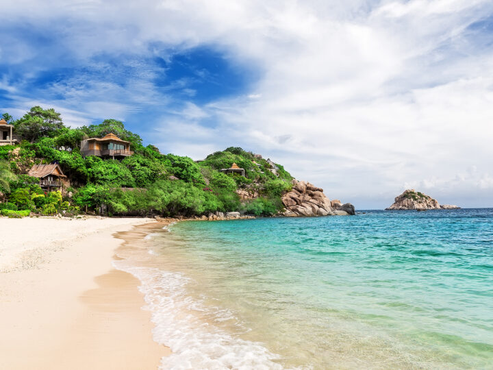 Koh Tao Thailand best family destinations for spring break beach with turquoise water with cliff and cabins in distance