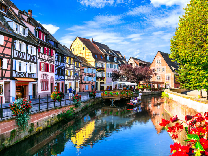 Alsace France river and colorful buildings on sunny day