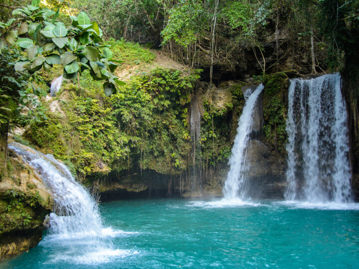 best family destinations for spring break Kawasan Falls on Cebu Island Philippines waterfall in lush jungle leading into teal water