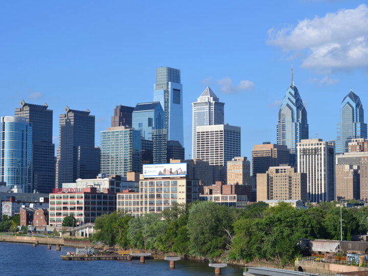 vibrant city buildings and riverfront on sunny day