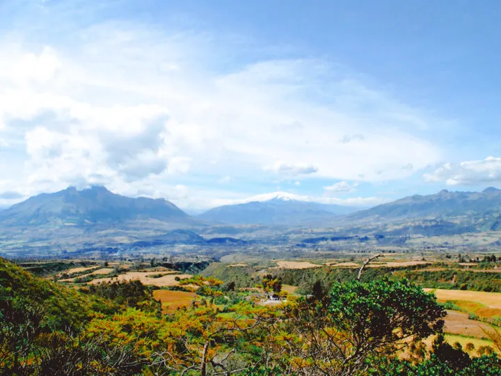 cheap spring break trips for families view of Ecuador landscape with mountains and trees with some clouds in sky