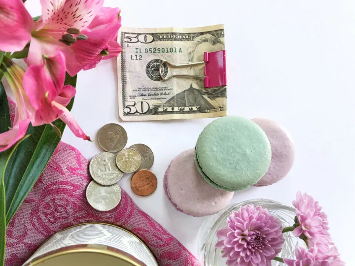 cheap winter date ideas view of 50 dollar bill and assorted flowers and macarons