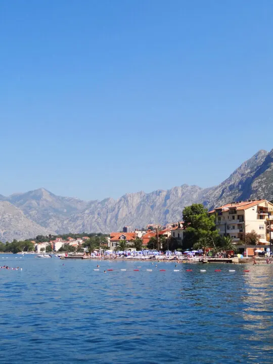 lake and shoreline of Montenegro with mountains in distance