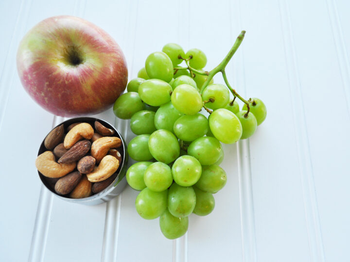 organize your home in winter photo of grapes apple and nuts in tin on white board