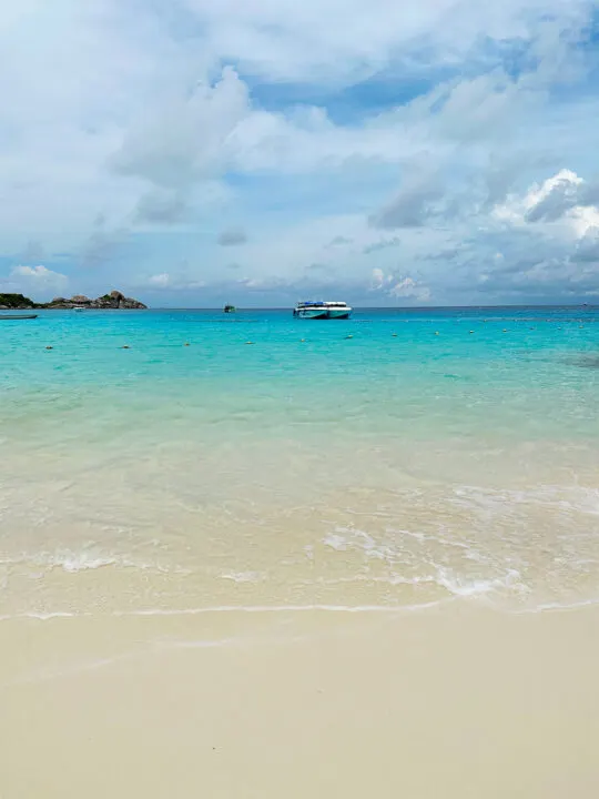 Koh Miang Similand Islands National Park Princess Beach looking at sand out to sea teal water and boats