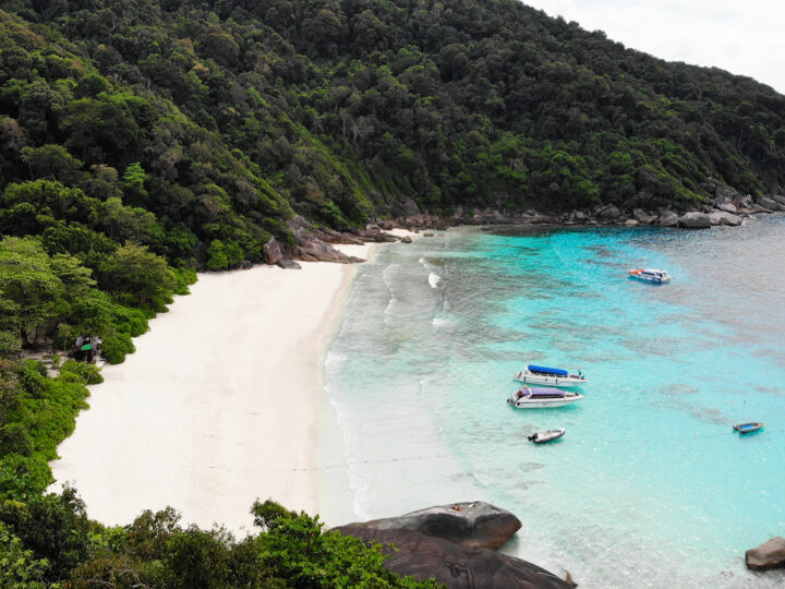 similan islands thailand view of beach in cove with white sand and boats on water