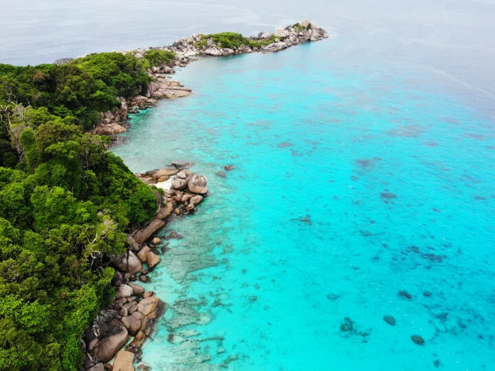 thailand islands tour from Phuket or khao lak beautiful teal water rocky shore and lush island