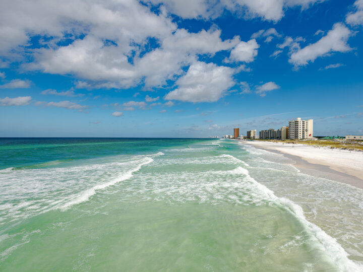 Panama City beach florida panhandle view of teal ocean white waves and hotels in distance