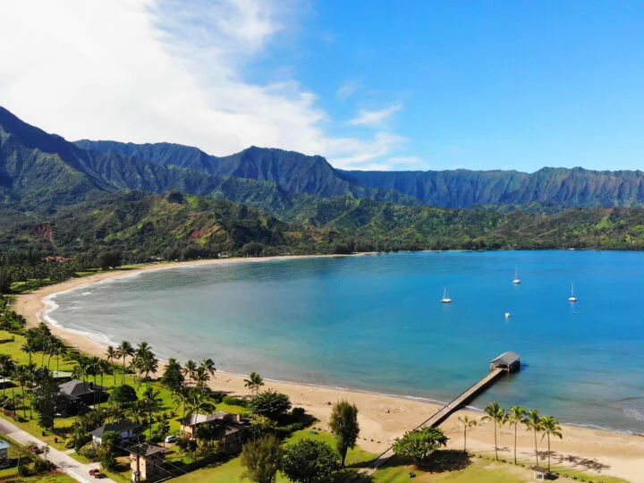 Hanalei Bay coastal aerial view of blue water beach and mountains