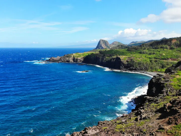 maui coastline blue water black rocky coast with lush greenery