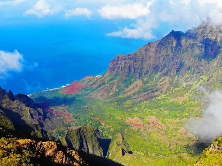 view of coastline green valley clouds and mountains