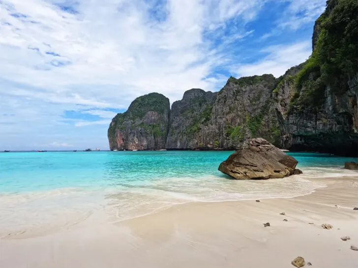 beautiful view of Maya Bay Phi Phi Islands rock on white sand beach with teal water and limestone cove