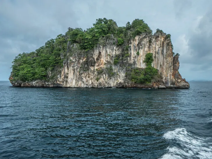view of mosquito island from a distance on stormy day limestone cliffs
