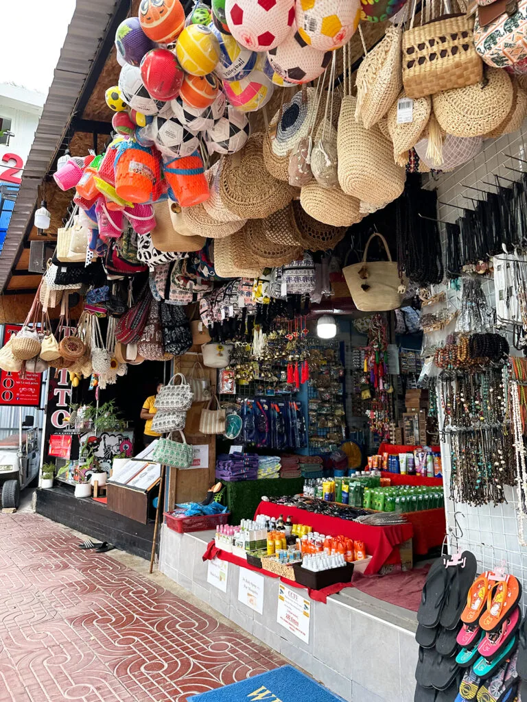 tonsai village shops in Thailand with jewelry, sunscreen, handbags and more accessories