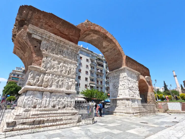 cruising the Greek islands view of large stone arch red and white stone