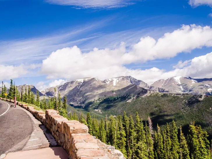 colorado trip planning view of road and Rocky Mountains with jagged peaks and trees