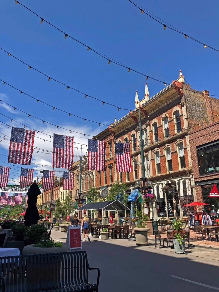 denver street with cafes and flags overhead