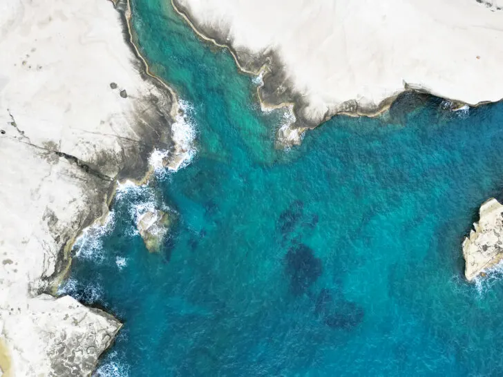 cruising Aegean Sea view of Sarakiniko in Milos Greece white rock landscape with bright blue contrast