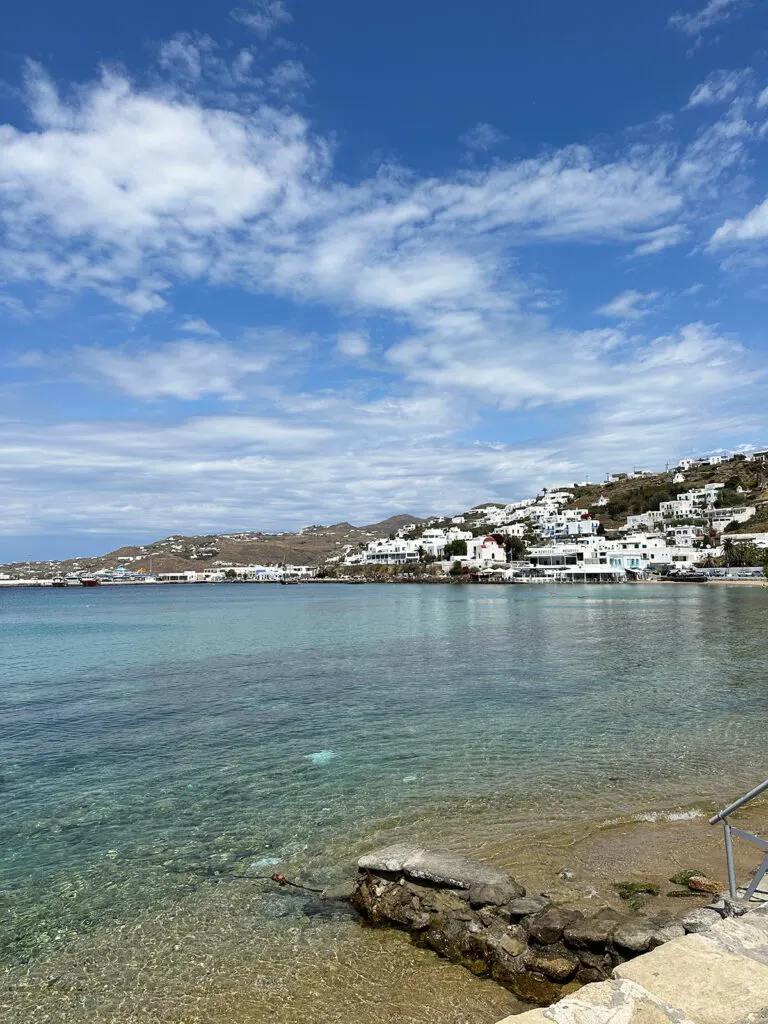 blue Aegean Sea with white Mykonos town in distance