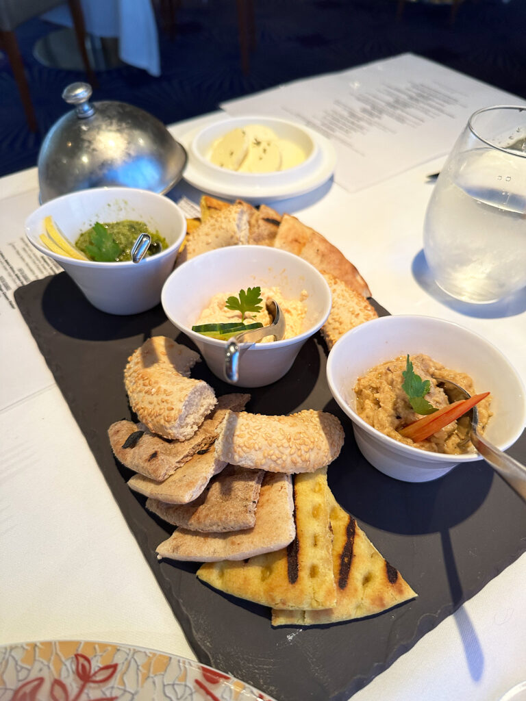assorted breads and dips with menus on table