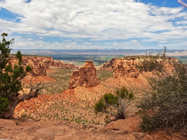 rocky structures and canyon with cloudy sky above