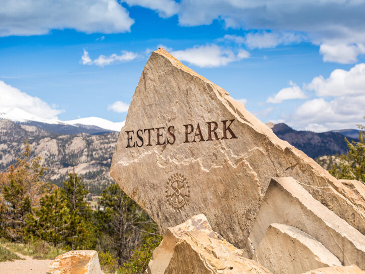 colorado road trip sign on rock that reads Estes Park