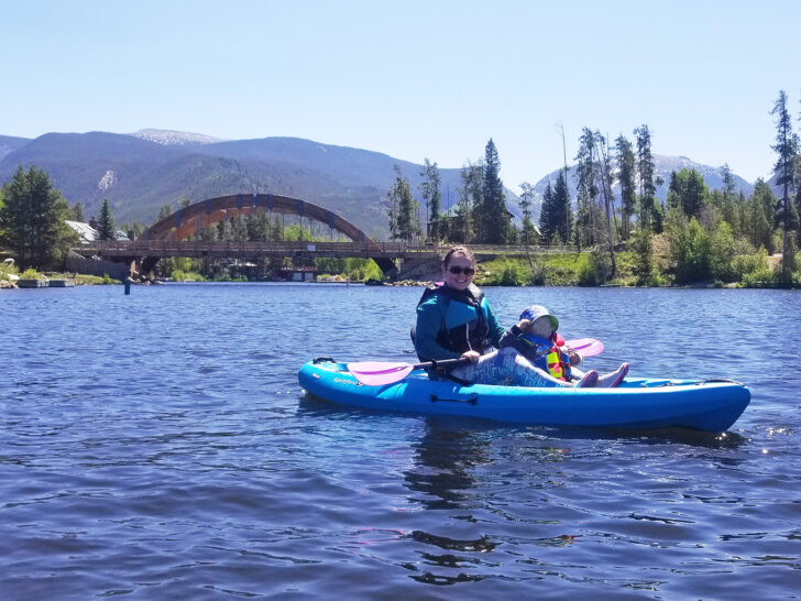 colorado itinerary 5 days view of woman and small child kayaking with bridge and mountains in distance