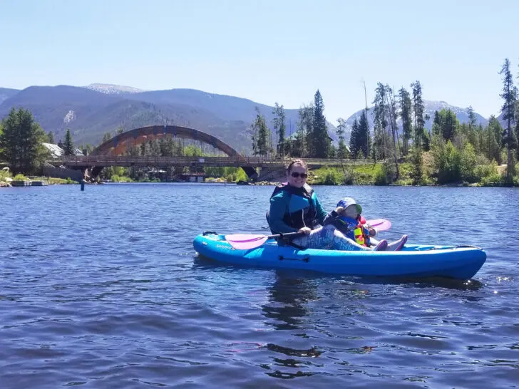 colorado itinerary 5 days view of woman and small child kayaking with bridge and mountains in distance