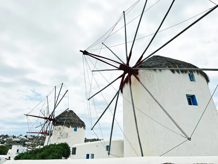 Santorini or mykonos view of large windmills with white buildings on cloudy day