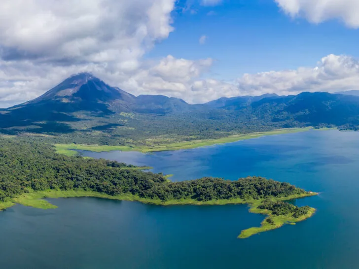 lake with trees and arenal volcano large mountain peak