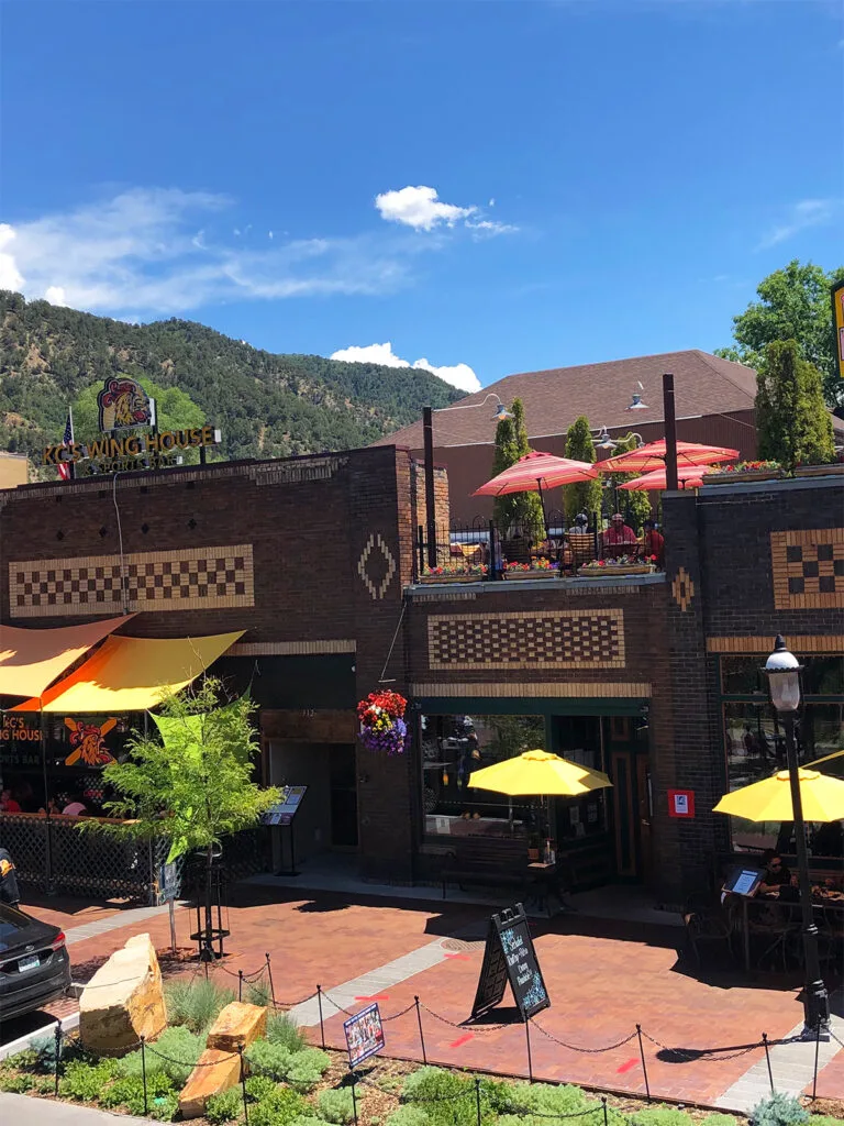 Colorado itinerary view of downtown buildings with umbrellas for eating under on sunny day