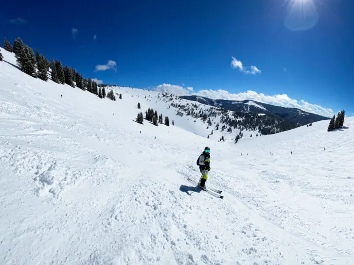 road trip Colorado view of skier on snowy mountainside slope