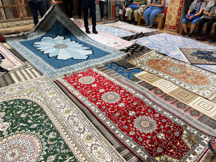multicolored Turkish rugs on floor for cruise passengers to buy