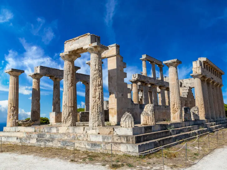 best Greek islands for couples view of ancient ruins stacked stones creating pillars on sunny day