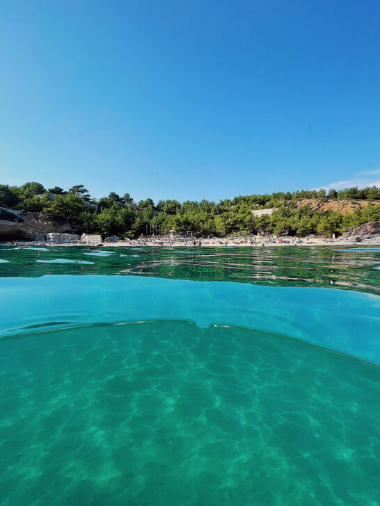 best island in greece for couples view of teal water looking toward shore with